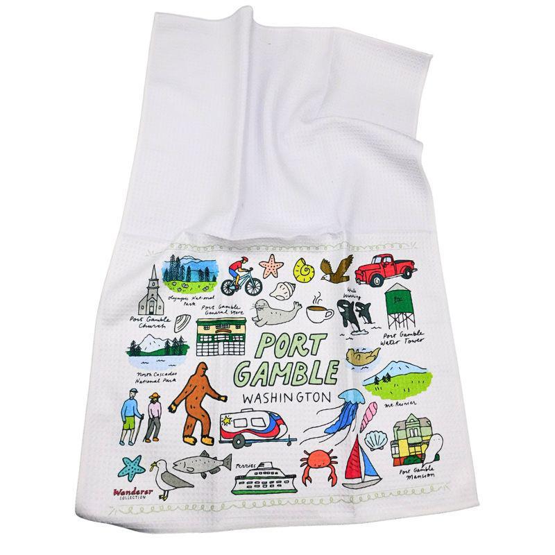 White towel with colorful illustrations and text about Port Gamble, Washington