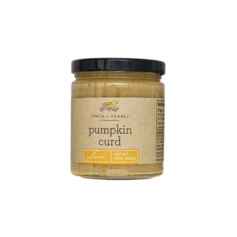 Jar of pumpkin curd with a black lid on a white background