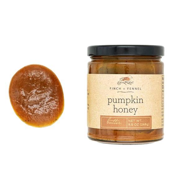 A jar of Finch + Fennel Pumpkin Honey butter with a black lid and beige label, shown next to a circular swatch of the thick amber-brown honey butter on a white background.