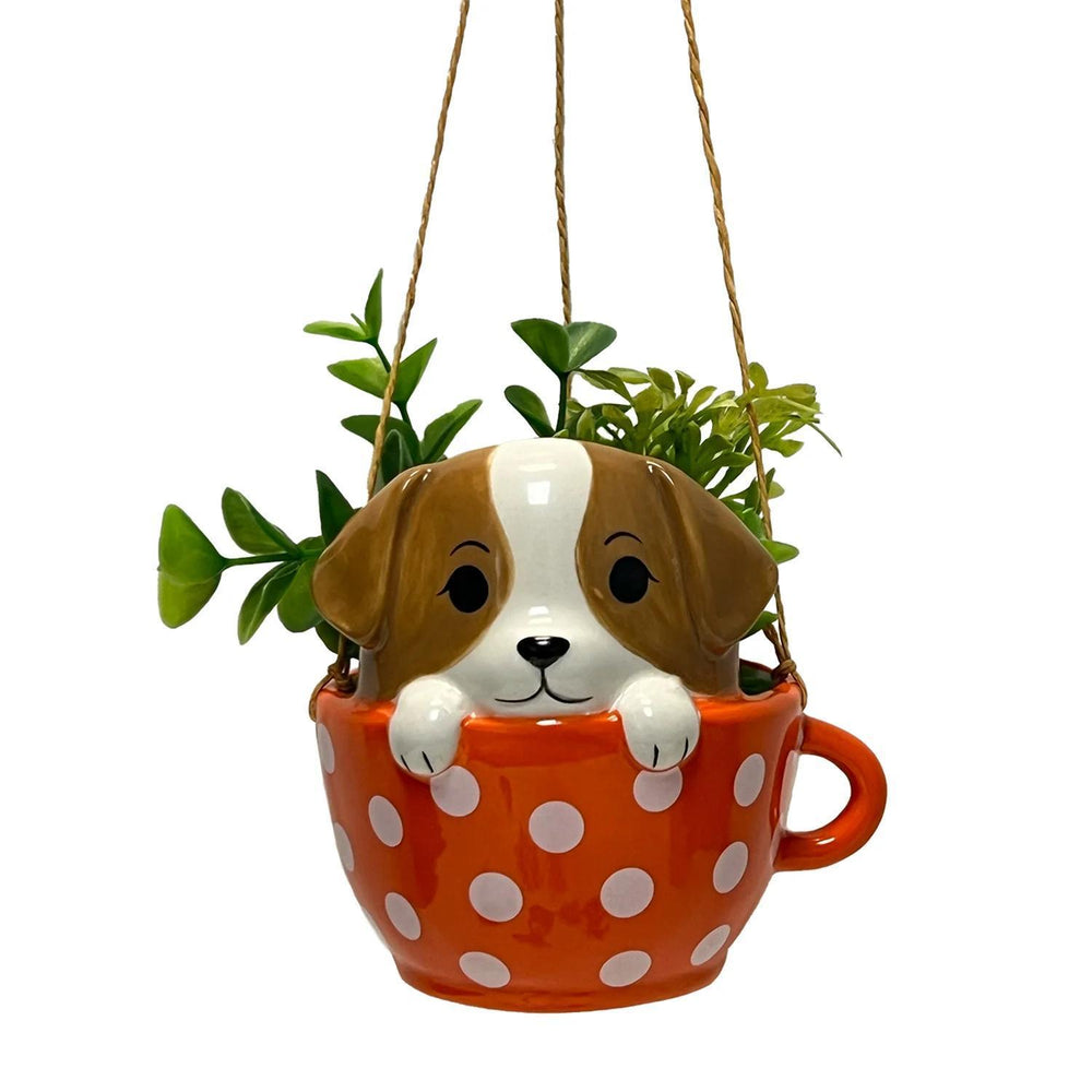 Hanging planter shaped like a dog in an orange polka dot cup with greenery.