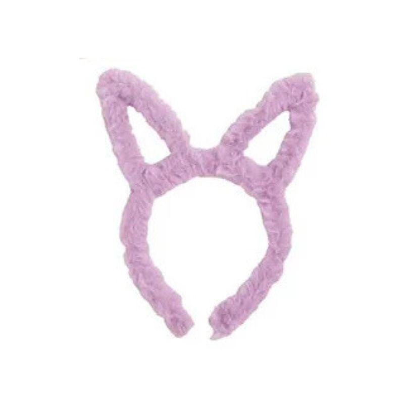 Purple fluffy bunny ears headband on a white background