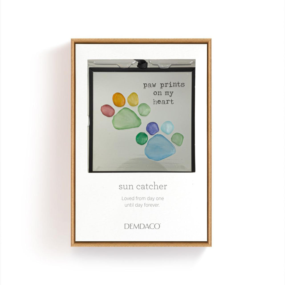 Framed artwork with colorful paw prints and text on a white background