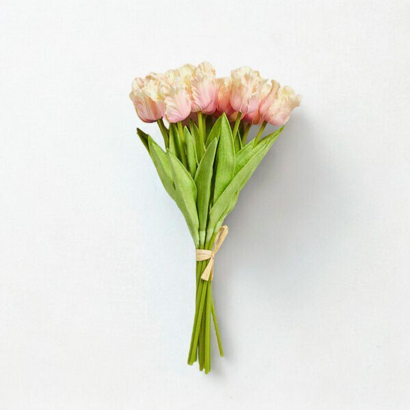 Bouquet of pink tulips tied with twine on a white background