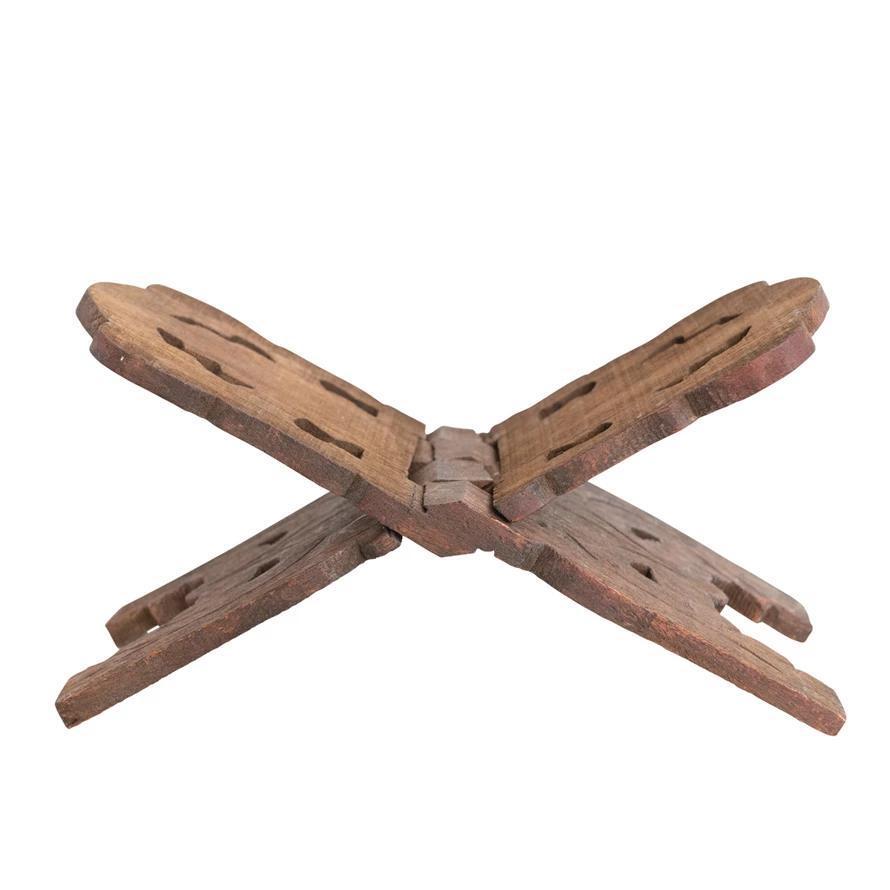 Wooden cross-shaped object on a white background