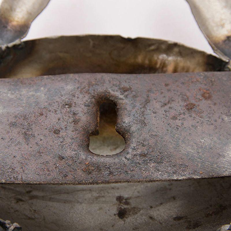 Close-up of a rusty metal object with a worn-out surface