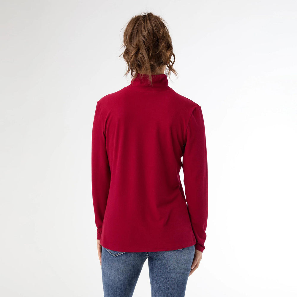 Person wearing a red turtleneck sweater on a white background