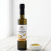 Bottle of roasted garlic infused olive oil with a small bowl of oil on a white background
