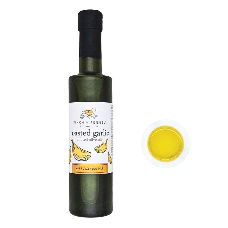 Bottle of roasted garlic infused olive oil with a close-up of the label on a white background.