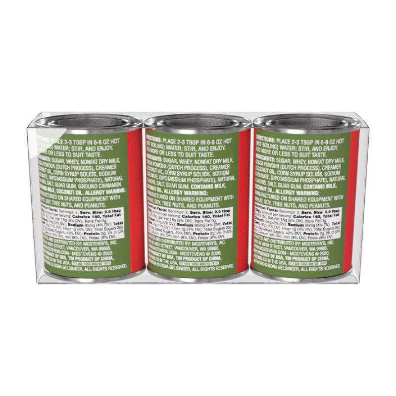 Three cans with green and red labels on a white background