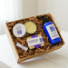 Set of natural skincare products in a box with a white background