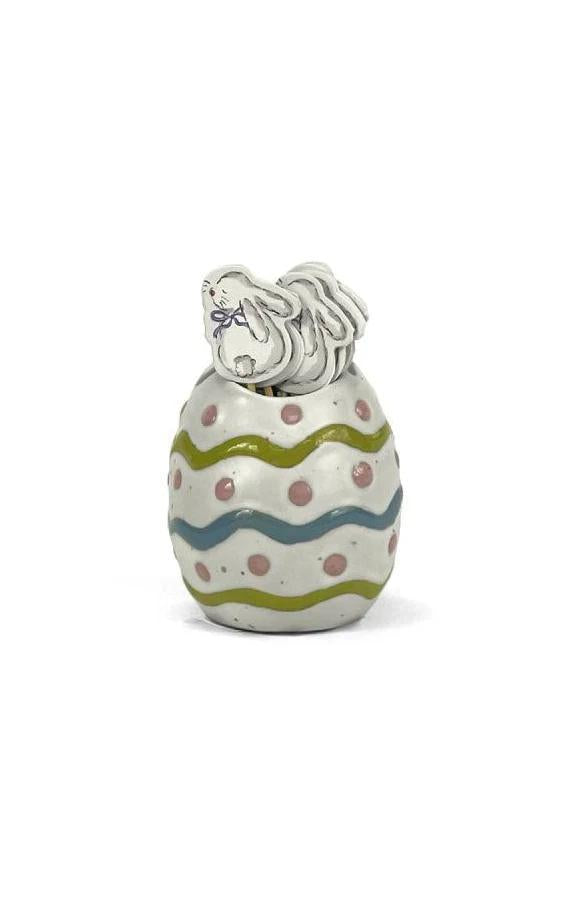 Decorative ceramic egg with a horse design on a white background