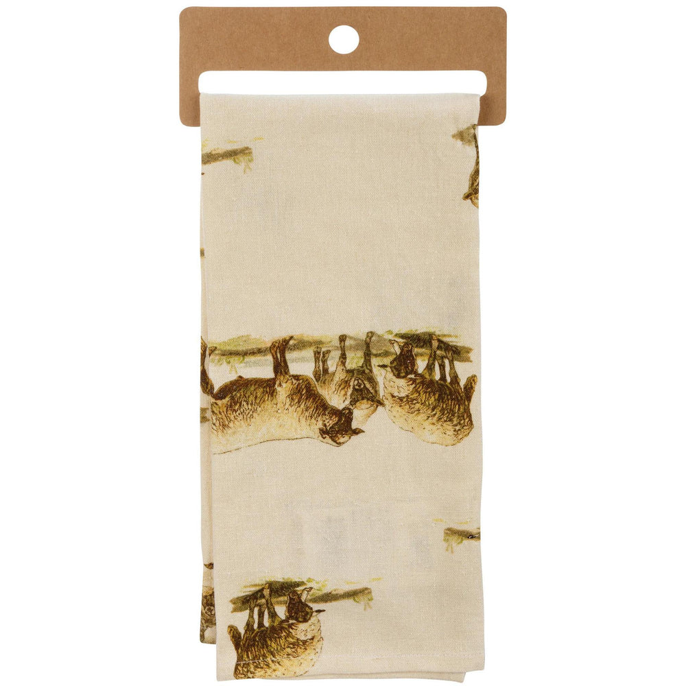 Beige towel with brown animal print hanging on a cardboard holder.