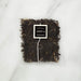 Tea bag with a label on a white marble surface