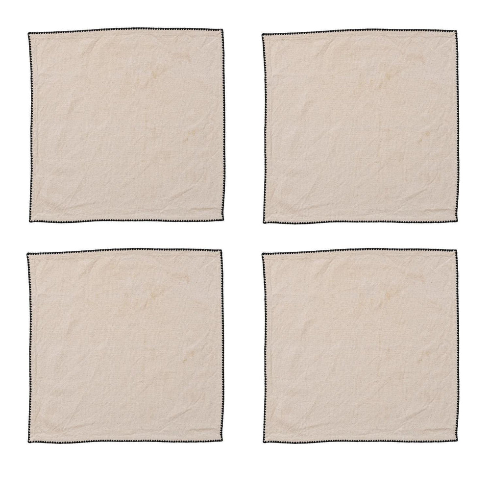 Four beige napkins with black borders on a white background