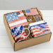 Gift set with American flag-themed items including a mug, napkins, and a box in a cardboard box.
