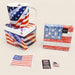 American flag-themed mug, napkins, and small items on a beige background