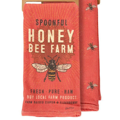 Red towel with bee design and 'Spoonful Honey Bee Farm' text on a white background
