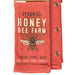 Red towel with bee design and 'Spoonful Honey Bee Farm' text on a white background