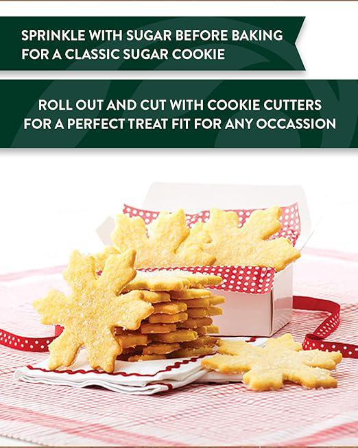 Snowflake-shaped cookies on a plate with text about baking and cutting cookies.