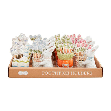Set of toothpick holders in a box with various designs on a white background
