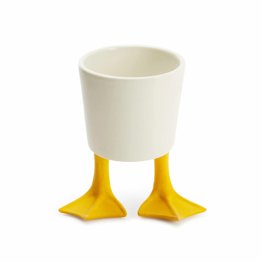 White cup with yellow feet on a white background