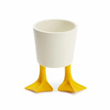 White cup with yellow feet on a white background