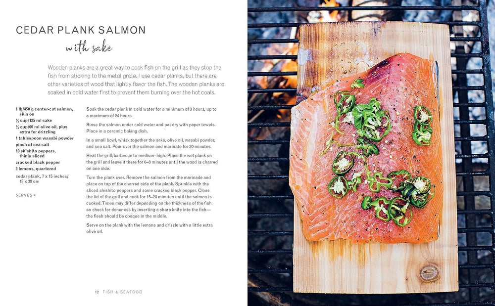 Salmon on a cedar plank with green onions on a grill