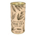 Canister of sweet and spiced chai tea latte mix with leaf designs on a beige background