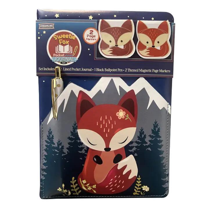 Fox-themed pocket journal set with pen and markers on a mountain and forest background