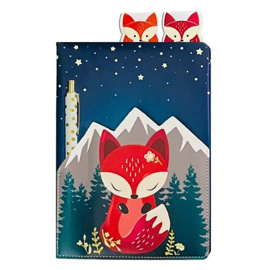 Notebook with fox design on a mountain landscape, accompanied by two small fox figurines.
