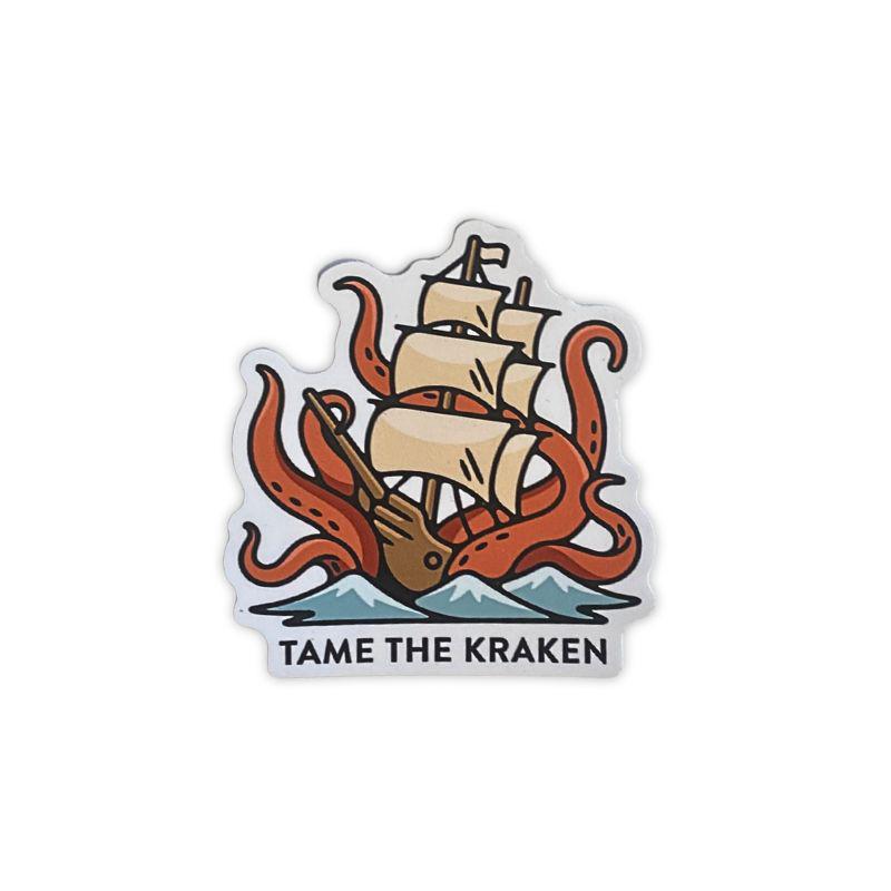 A die-cut sticker featuring an illustration of a sailing ship with beige sails and orange-red kraken tentacles wrapping around it, with the text 'TAME THE KRAKEN' below, shown on a plain white background.