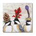 Three birds with floral and pinecone hats on a wooden background