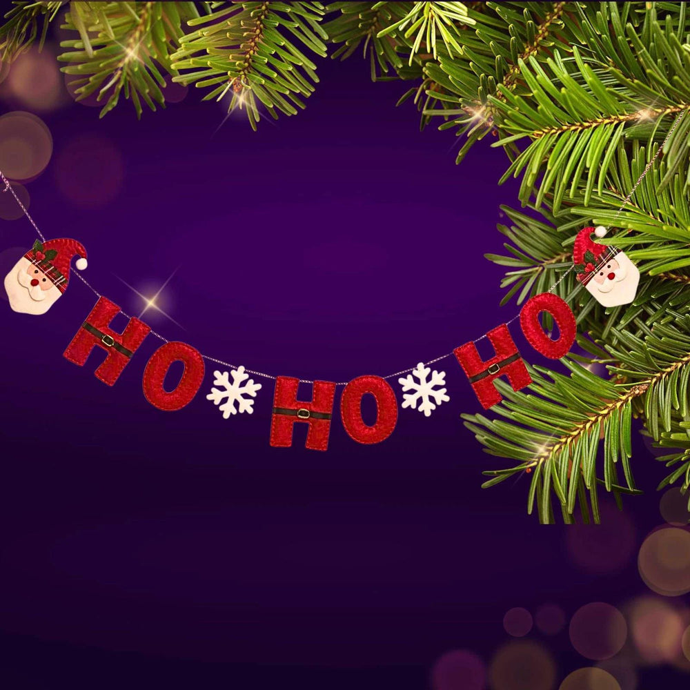 Christmas-themed banner with 'HO HO HO' text, snowflakes, and Santa Claus decorations on a purple background.