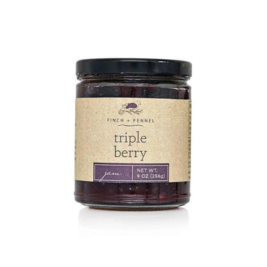 Jar of triple berry jam with a kraft paper label on a white background
