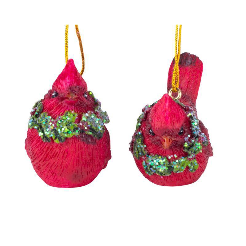 Two red bird ornaments with green wreaths on a white background