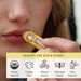 Person applying a yellow Moon Organics lip balm with branding and certification icons displayed.