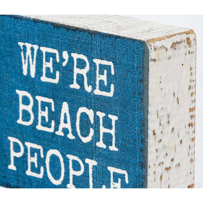 Wooden block with 'WE'RE BEACH PEOPLE' text on a blue background