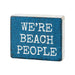 Blue block with white text 'WE'RE BEACH PEOPLE' on a white background