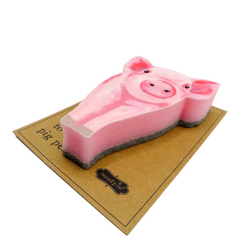 side view of a pink pig dish sponge. 