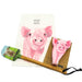 cute pink piglet themed gift set containing a cotton towel a spatula and a dish sponge