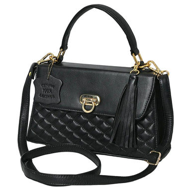 Black quilted handbag with gold accents on a light gray background