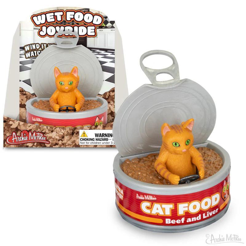 Cat-shaped toy inside a container labeled 'Cat Food' with packaging in the background.