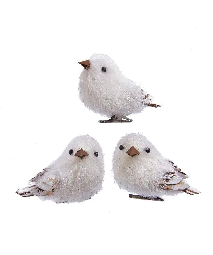 Three white fluffy birds with brown beaks on a white background