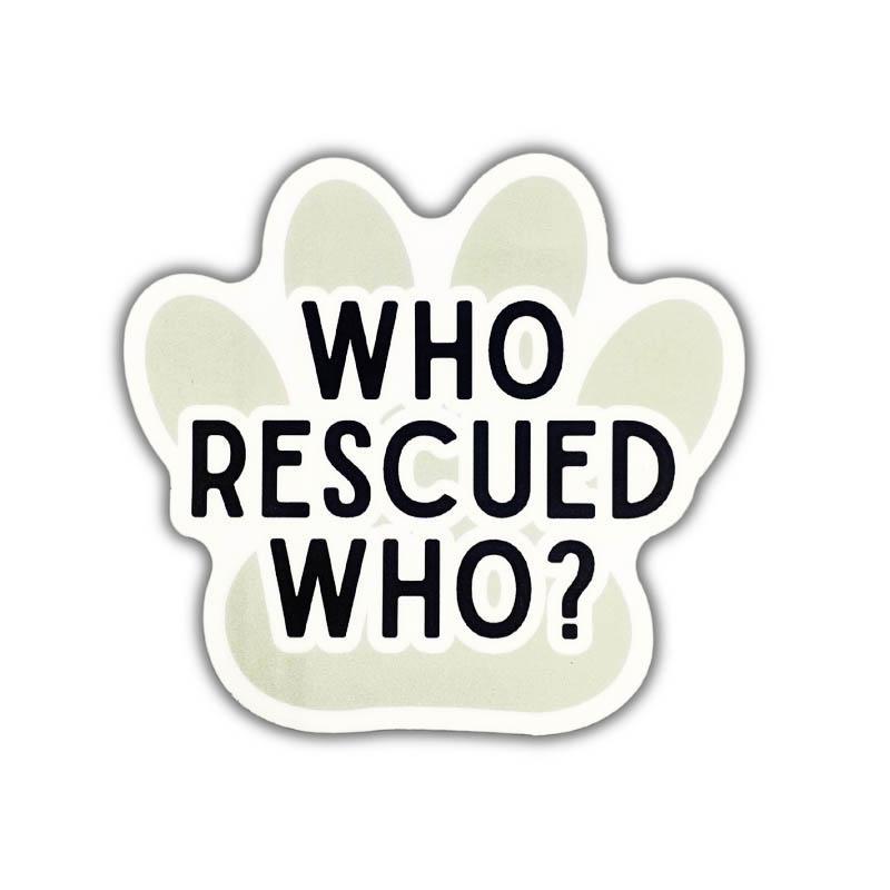 A paw-shaped sticker or decal with the text 'WHO RESCUED WHO?' in bold black letters on a pale sage green background with a white border, shown on a plain white background.