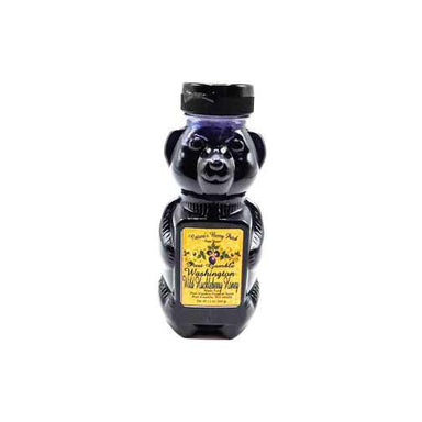A bear-shaped bottle of Washington Purple Honey with a black cap and a yellow label, shown against a plain white background.