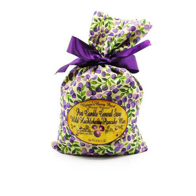 Bag of Wild Huckleberry Pancake Mix with a purple ribbon on a white background