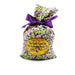 Bag of Wild Huckleberry Pancake Mix with a purple ribbon on a white background