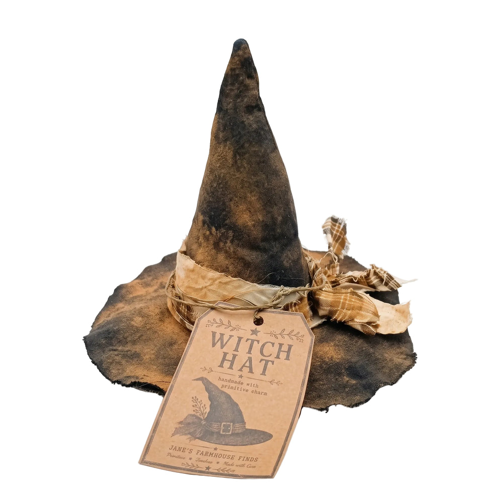 A rustic, distressed black and brown witch hat with a matching paper tag and ribbon, photographed on a clean white background.