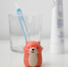 Cute animal-shaped bottle cap with a straw on a white background