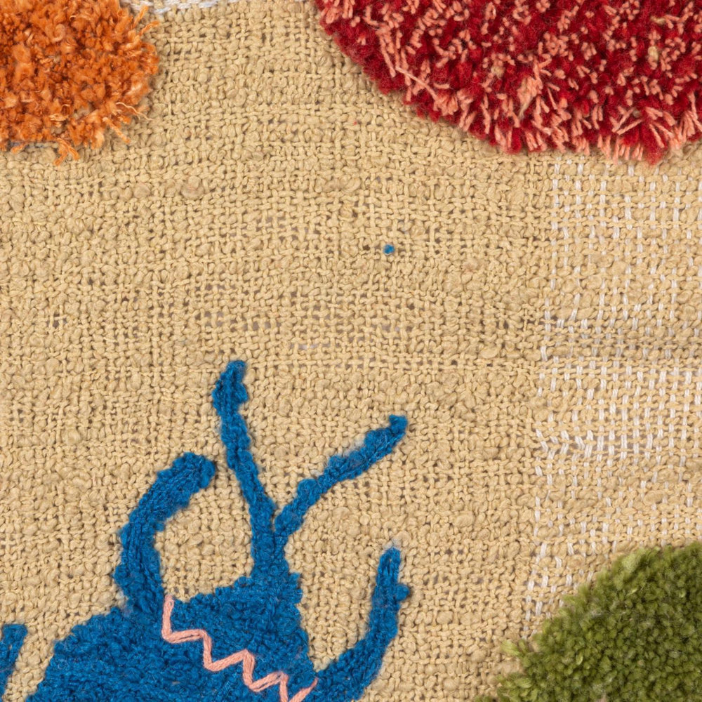 Close-up of a textured fabric surface with colorful floral patterns.